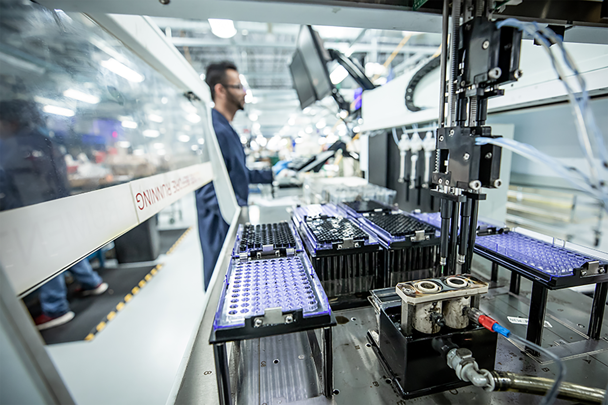 Automated high-throughput laboratory processing line handling rows of oil and grease analysis sample vials